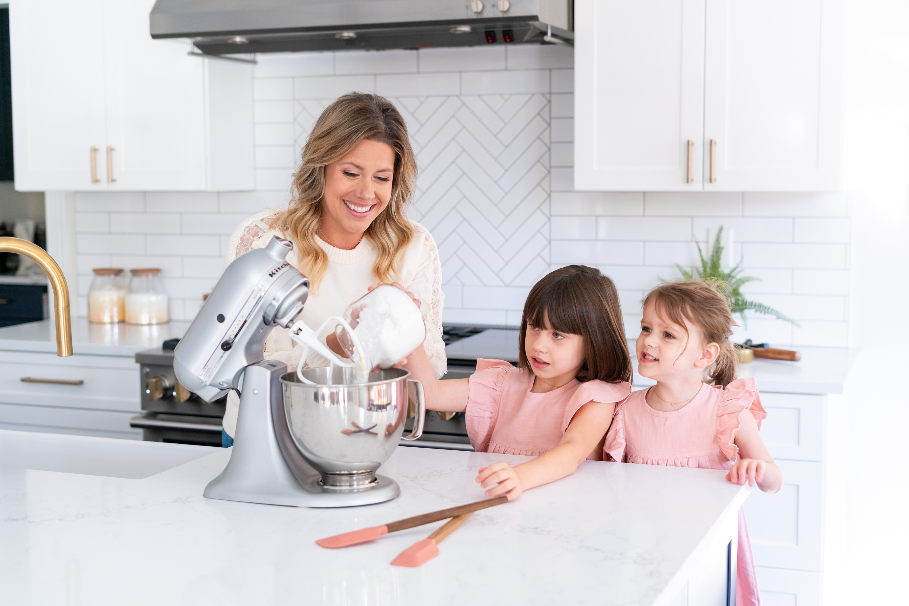 Mother and daughter baking together in beautiful kitchen - cookie decorating classes