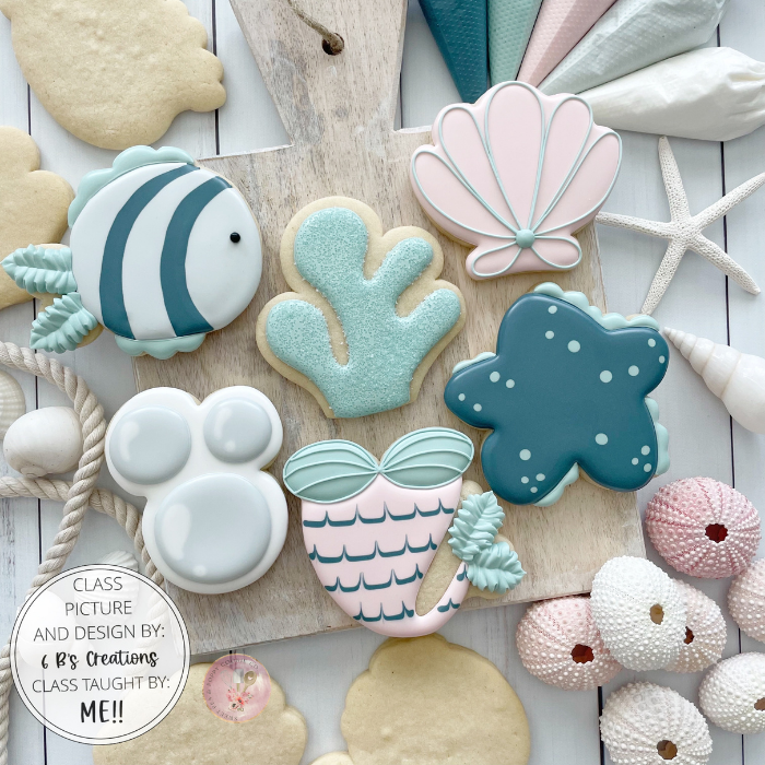 Students learning cookie decorating techniques with Sweet Pea & Poppy professional instruction